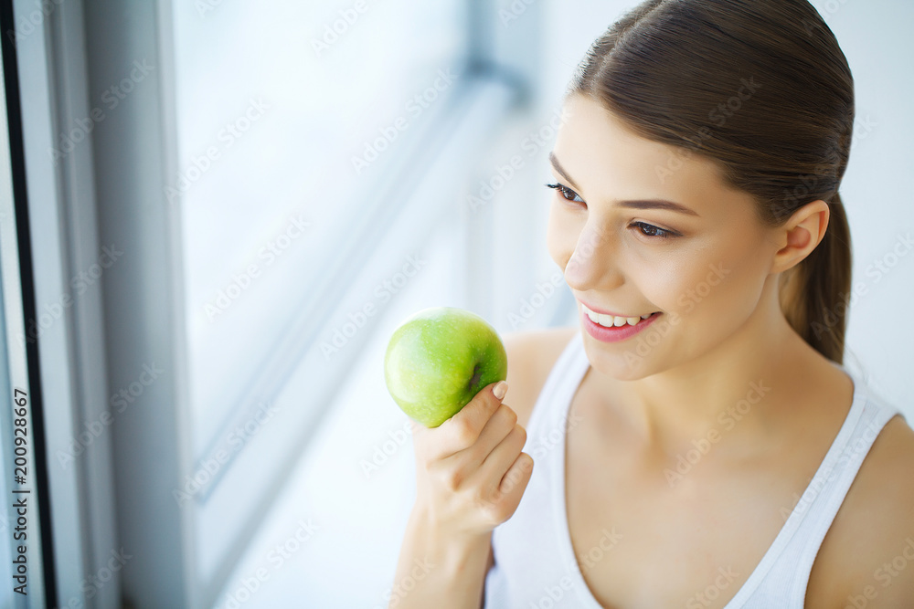 Woman Eating Apple. Beautiful Girl With White Teeth Biting Apple. High Resolution Image Woman Eating Apple. Beautiful Girl With White Teeth Biting Apple. High Resolution Image