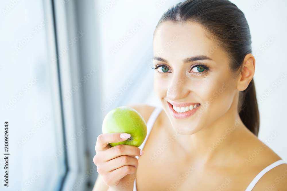 Woman Eating Apple. Beautiful Girl With White Teeth Biting Apple. High Resolution Image Woman Eating Apple. Beautiful Girl With White Teeth Biting Apple. High Resolution Image