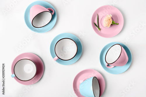 Elegant porcelain blue and pink cups on abstract background