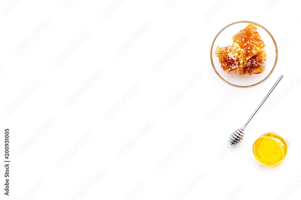 Apiary products. Honey in bowl and honeycomb on white background top view copy space Apiary products. Honey in bowl and honeycomb on white background top view copy space