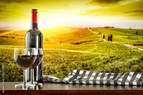 Fototapeta Naklejka Na Ścianę i Meble -  Wine on desk and Tuscany landscape 