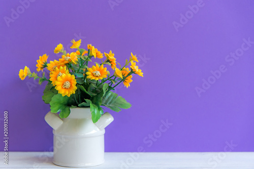 Wallpaper Mural Purple wall with yellow flower on shelf white wood, copy space for text. Still life Concept Torontodigital.ca