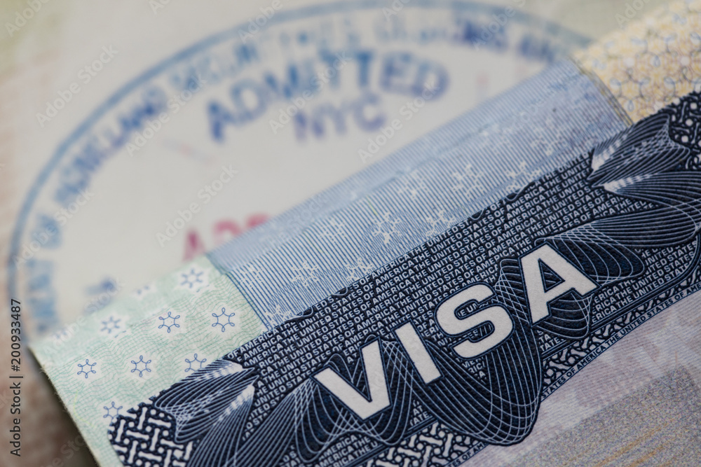 Obraz premium Close up of a Visa spamp in a passport. Immigration and emigration concept