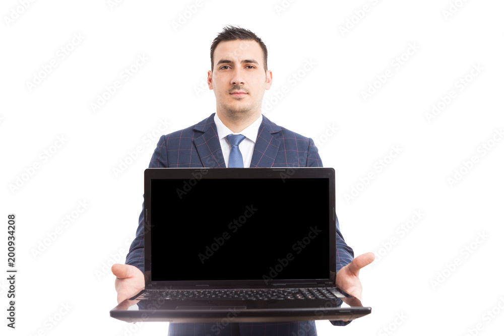 Young handsome broker holding laptop with empty screen. Young handsome broker holding laptop with empty screen.