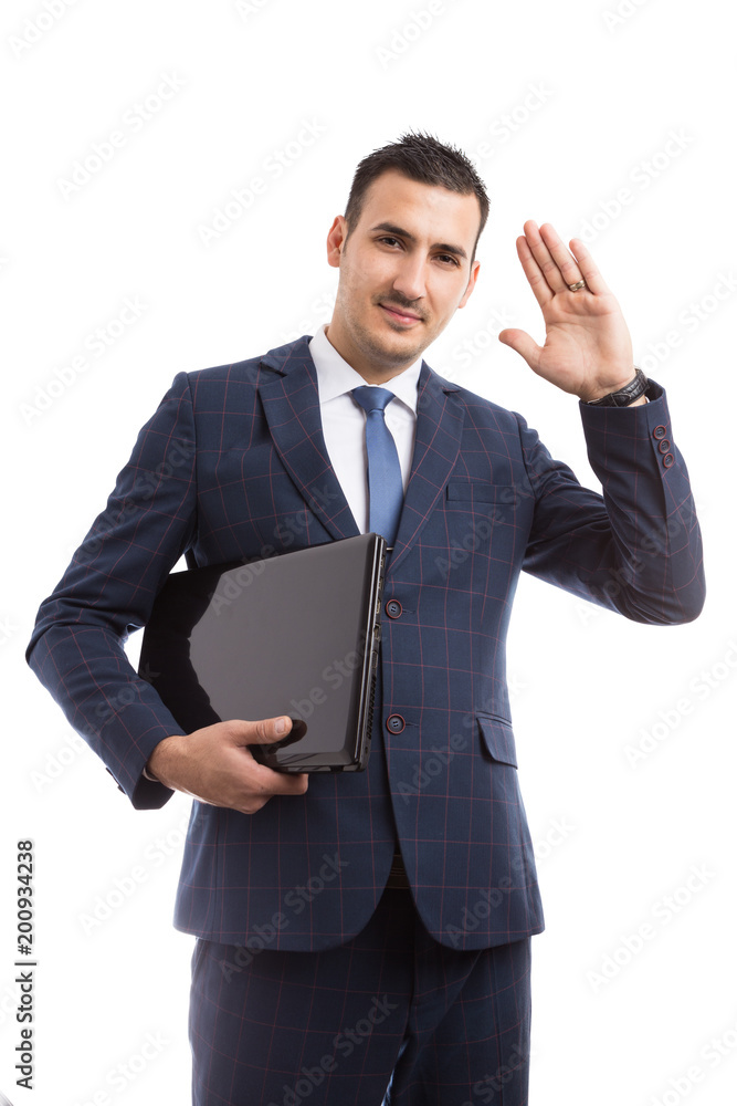 Young handsome salesman holding laptop and waving. Young handsome salesman holding laptop and waving.