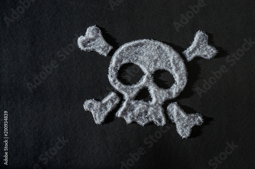 skull made of sugar  sugar crystals in the shape of a skull on a dark background  concept about the dangers of sugar