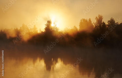 River and solar fog. Early morning with sunrise. Backlighting