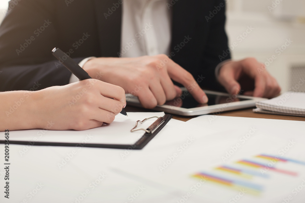 Business colleagues using tablet and working with documents Business colleagues using tablet and working with documents