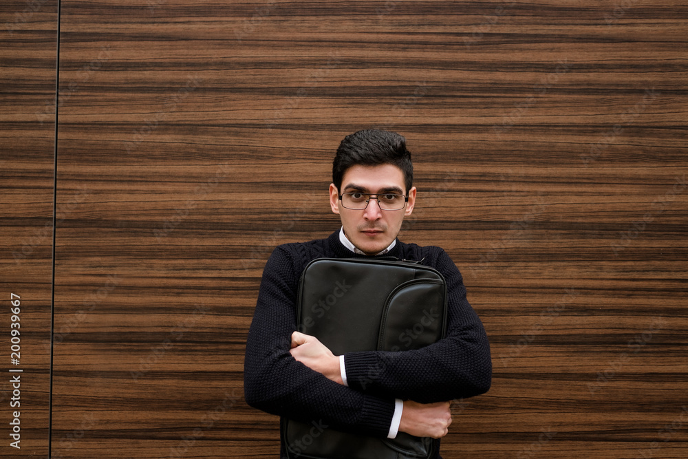 security papers protection. dangerous financial market. scared anxious business man holding his briefcase tightly. free space concept security papers protection. dangerous financial market. scared anxious business man holding his briefcase tightly. free space concept