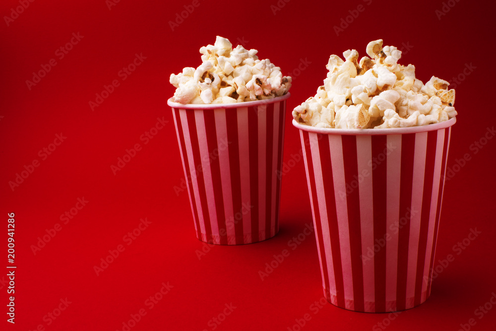 popcorn in two hollow boxes on a red background popcorn in two hollow boxes on a red background