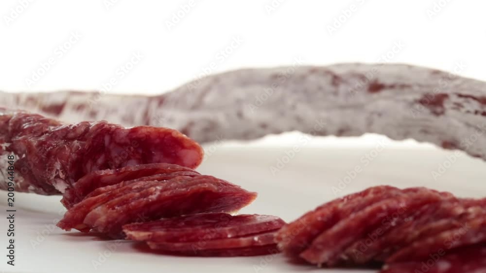 CLoseup of woman taking slice of tasty dry cutted italian sausage. CLoseup of woman taking slice of tasty dry cutted italian sausage.
