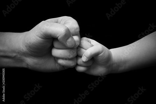 father and child touching fists
