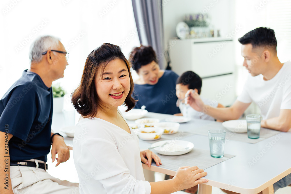 Happy Asian extended family having dinner at home full of happiness and smiles Happy Asian extended family having dinner at home full of happiness and smiles