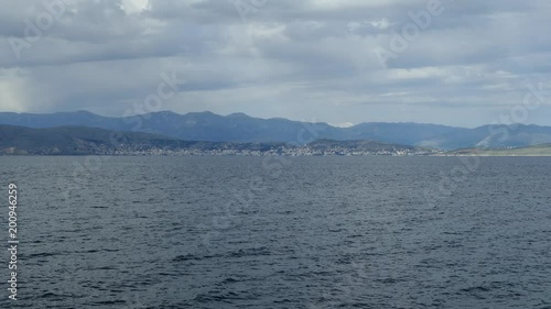 Beautiful sea landscape with clear turquoise water of Ionian Sea. Blue lagoon beach coast, Kassiopi, Corfu Island, Greece. Natural background with dark stormy clouds. photo