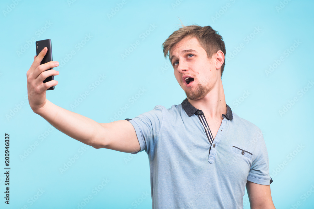 Funny man grimacing while making selfie Funny man grimacing while making selfie