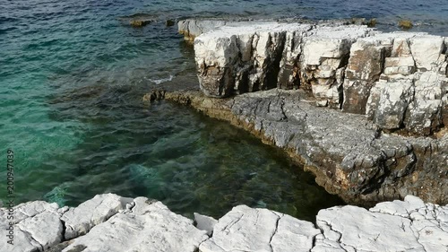 Blue lagoon beach coast, Kassiopi village, Corfu Island, Greece. Rocky coast of Ionian Sea with clear turquoise water. photo
