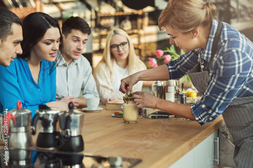 Experienced smiling barista giving master class