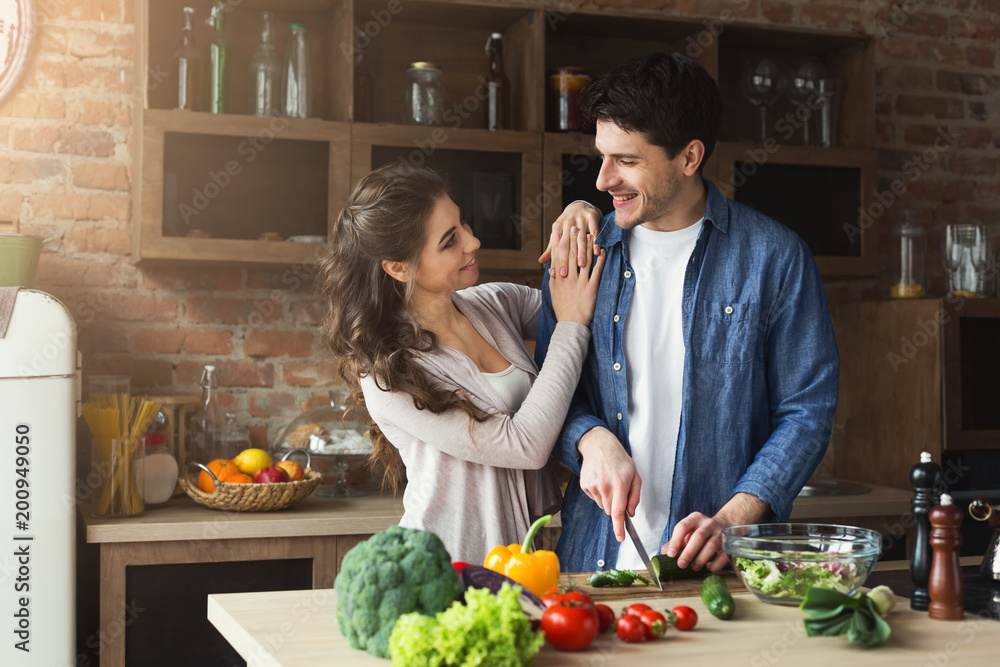 Happy couple cooking dinner together