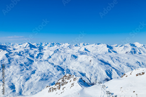 Alpine winter landscape of slopes, off piste skiing and ski lift, in the highest French resort of Val Thorens, Les Trois Vallees