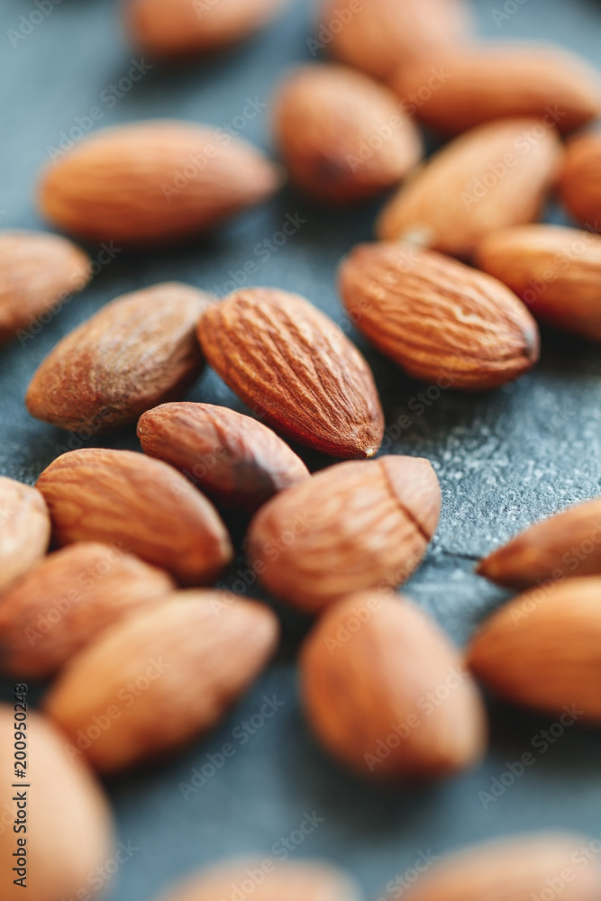 Macro photography of almond nuts over grey background. The concept of healthy and organic food. Macro photography of almond nuts over grey background. The concept of healthy and organic food.