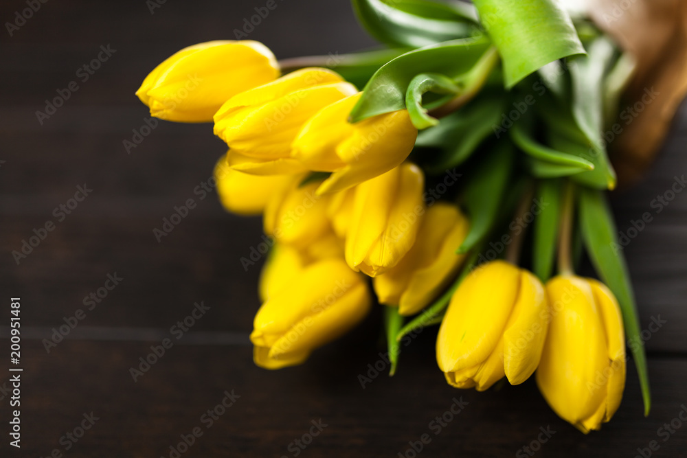 Yellow tulips on wooden background Yellow tulips on wooden background