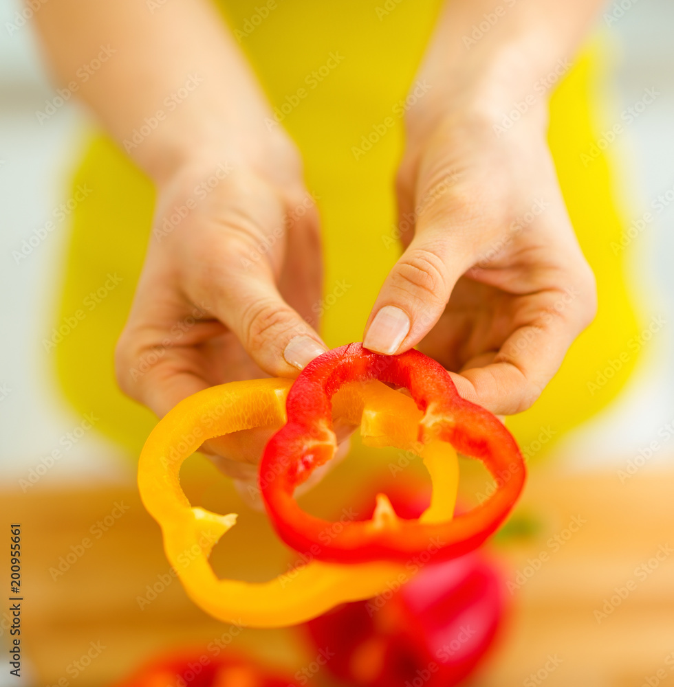 Closeup on slices of bell pepper in hand of woman Closeup on slices of bell pepper in hand of woman