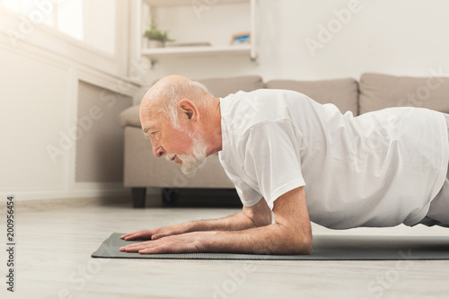 Senior man fitness workout, push ups or plank