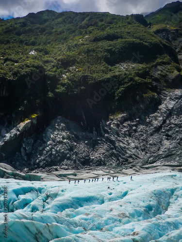A group of tourists take a guided walk on Fox Glacier South Island New Zealand