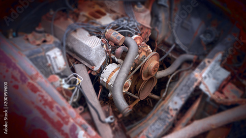 A close up view of an old rusty car engine.