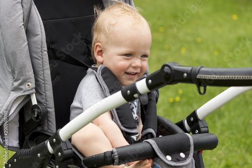 Cute Baby boy sitting stroller on nature