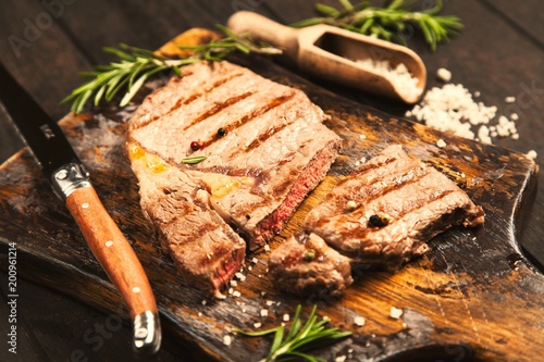 Grilled steak on wooden cutting board