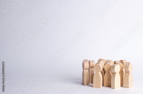 A crowd of people on a white background. People stand in the crowd and discuss. Cooperation and work together. Follows the leader, herd instinct. A company of friends, a political movement.