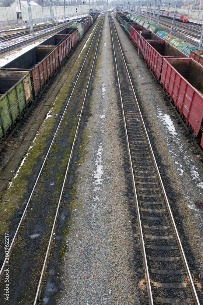 Railway station in winter and freight trains