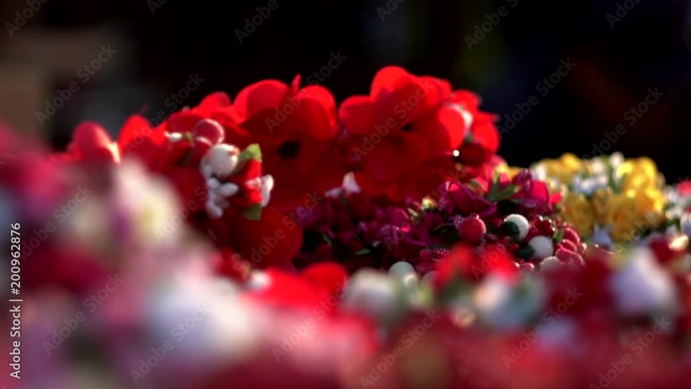 National Ukrainian floral hair wreath in warm sunlight. A symbol of Ukraine, traditional ethnic boho-style vinok. A crown of multicolor flowers and berries, close-up. National Ukrainian floral hair wreath in warm sunlight. A symbol of Ukraine, traditional ethnic boho-style vinok. A crown of multicolor flowers and berries, close-up.