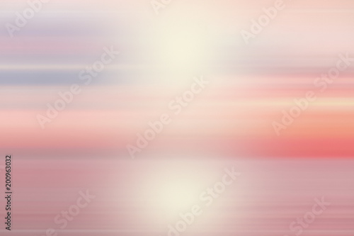 Peaceful Abstract blur beautiful purple ocean with pink sky sun background.