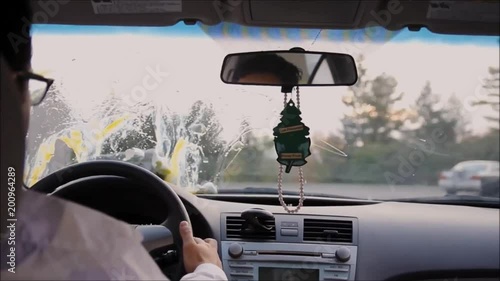 Man in a Drive Thru when a carton of eggs falls on his windshield photo