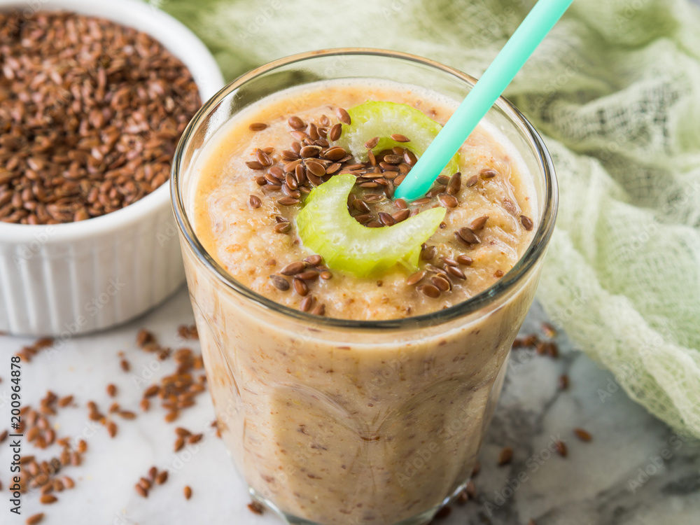 Smoothie with fennel, apple, carrots, celery and flax seeds on marble table background Smoothie with fennel, apple, carrots, celery and flax seeds on marble table background