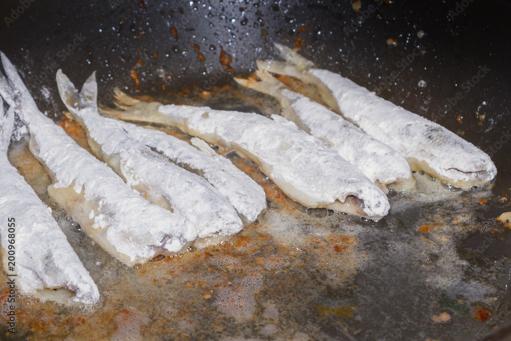 Cooking fried fish smelt rolled in flour Cooking fried fish smelt rolled in flour