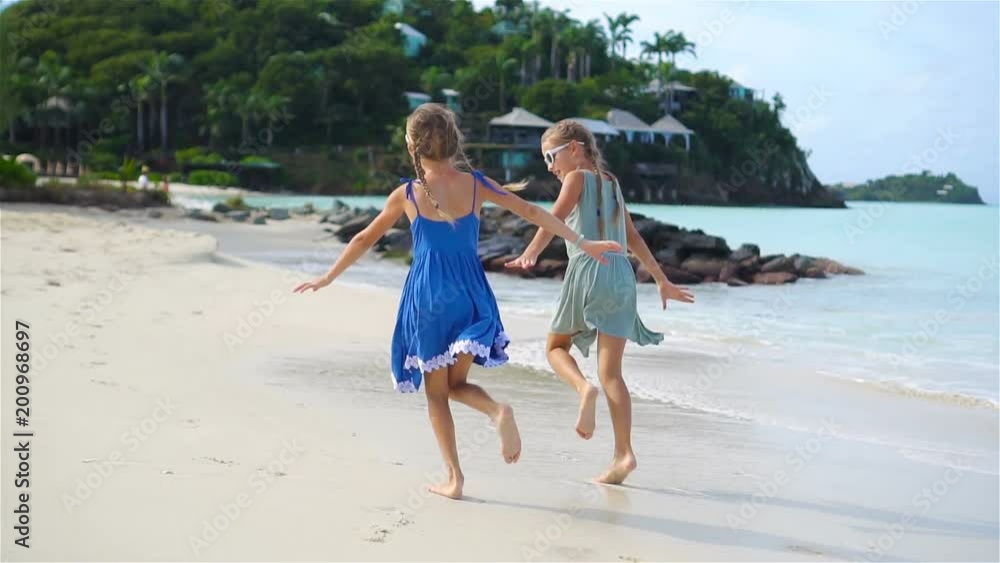 Adorable little girl on the beach having fun on caribbean island. SLOW MOTION Adorable little girl on the beach having fun on caribbean island. SLOW MOTION