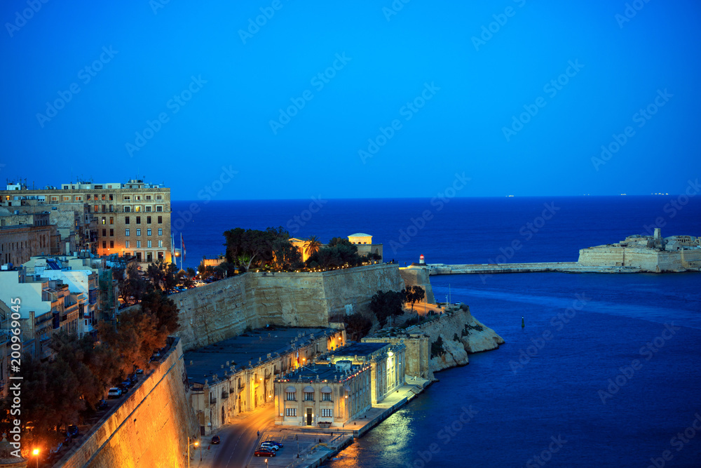 Valletta, Malta. Grand harbor entrance view from Upper Barrakka Gardens in the evening