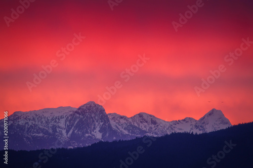 peak of mountains with red sunset and stormy weather backgrounds