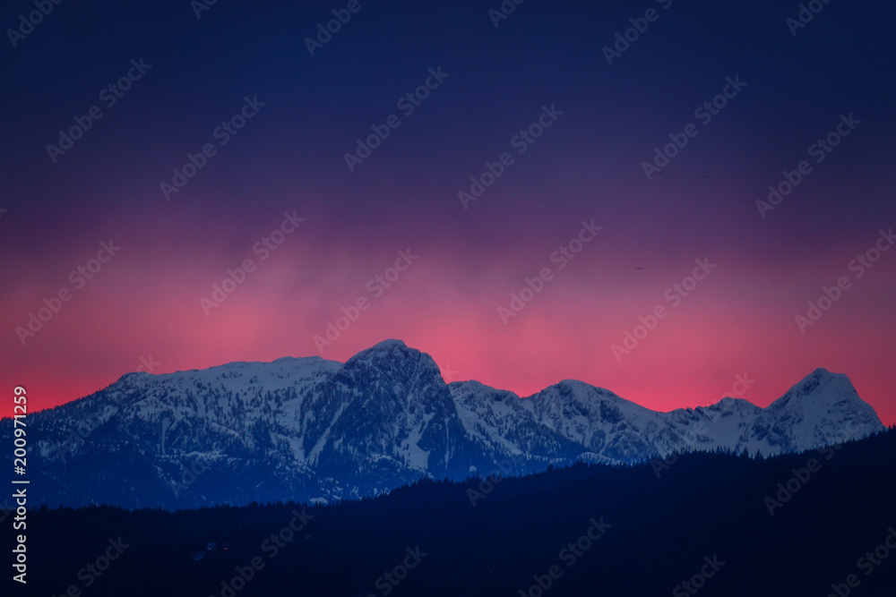 peak of mountains with red sunset and stormy weather backgrounds