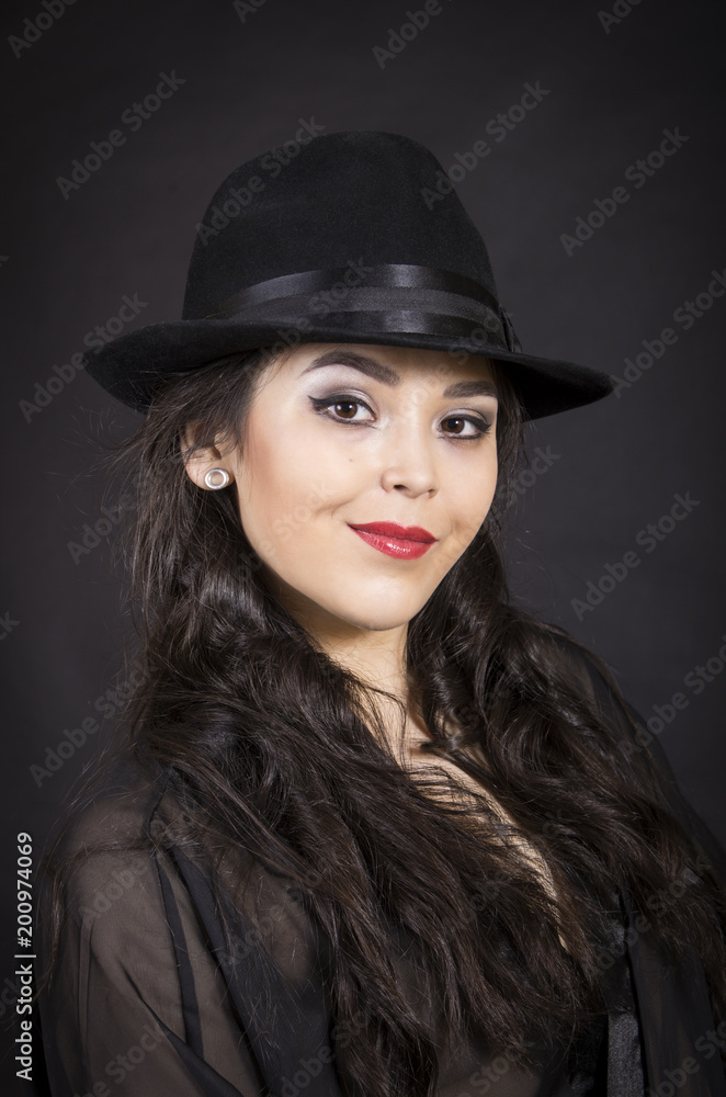 Beautiful young girl in black tunic, black gloves and black hat. Beautiful young girl in black tunic, black gloves and black hat.