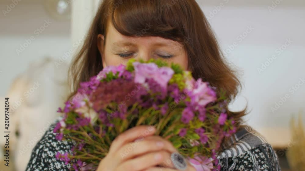 A woman judges flowers and laughs A woman judges flowers and laughs
