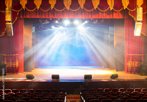 The stage of the theater illuminated by spotlights from the auditorium