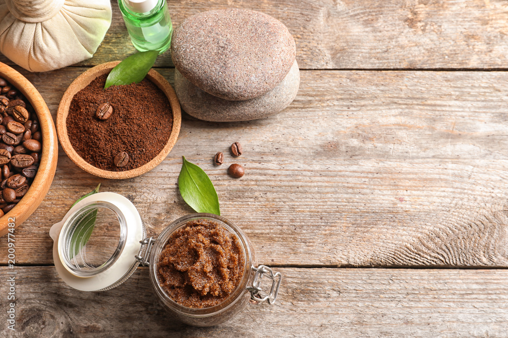 Composition with handmade natural body scrub and coffee on wooden background Composition with handmade natural body scrub and coffee on wooden background