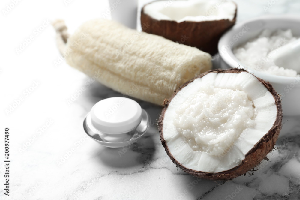 Composition with handmade natural body scrub in nut on light background Composition with handmade natural body scrub in nut on light background