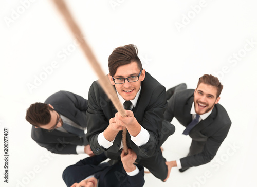 business team helping the leader to climb the rope