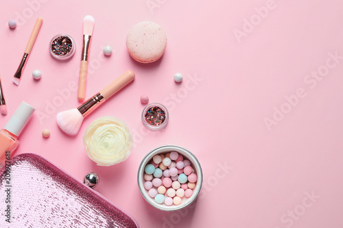 Makeup products with cosmetic bag on color background