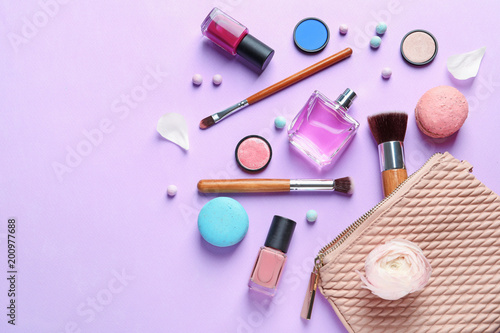Makeup products with cosmetic bag on color background